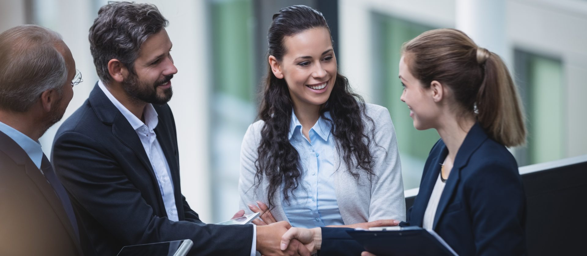 Group of businesspeople having a discussion near staircase in office